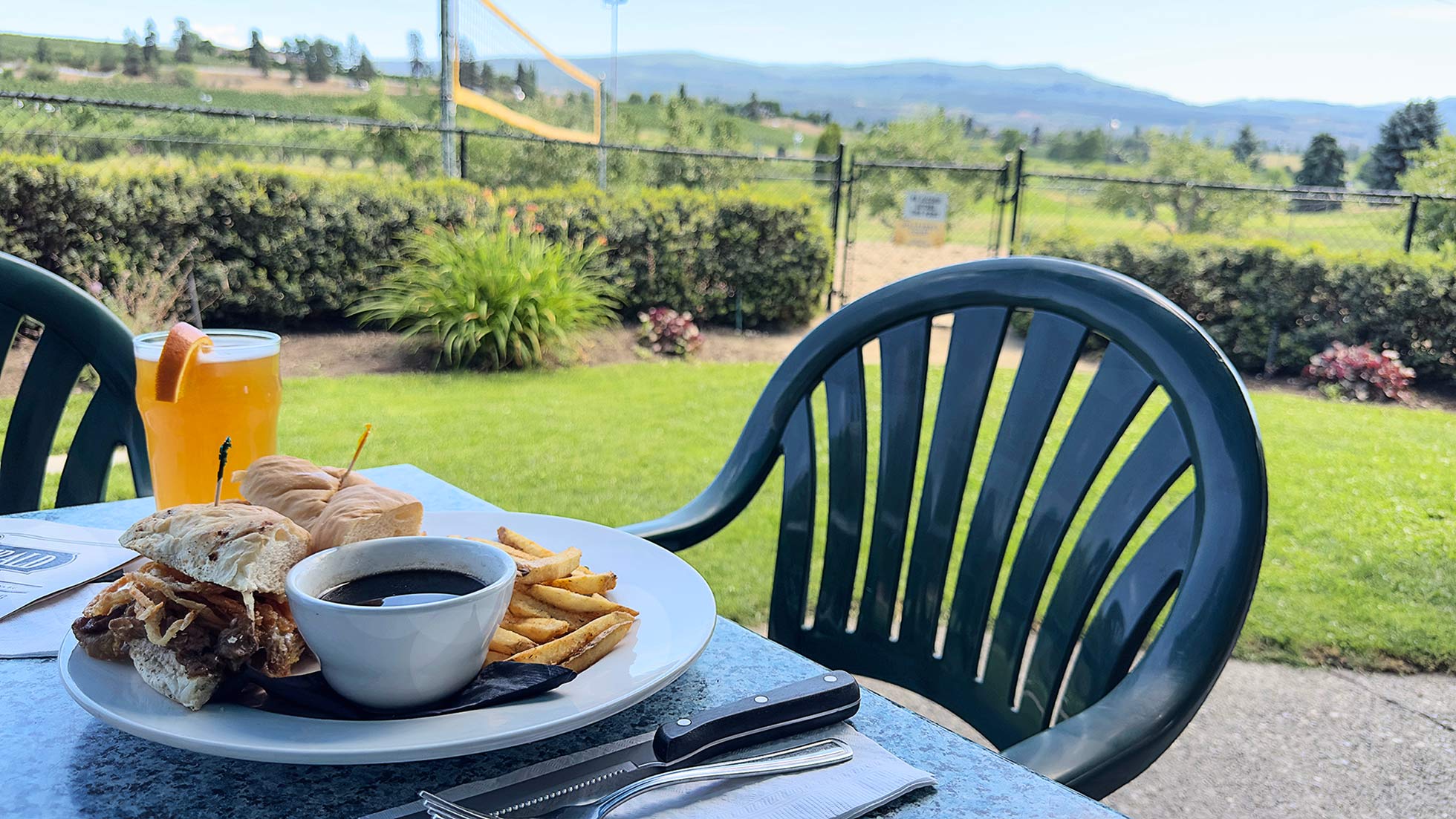 a picture of McCulloch's Rib Eye Dip on the patio, with a stunning view as a background